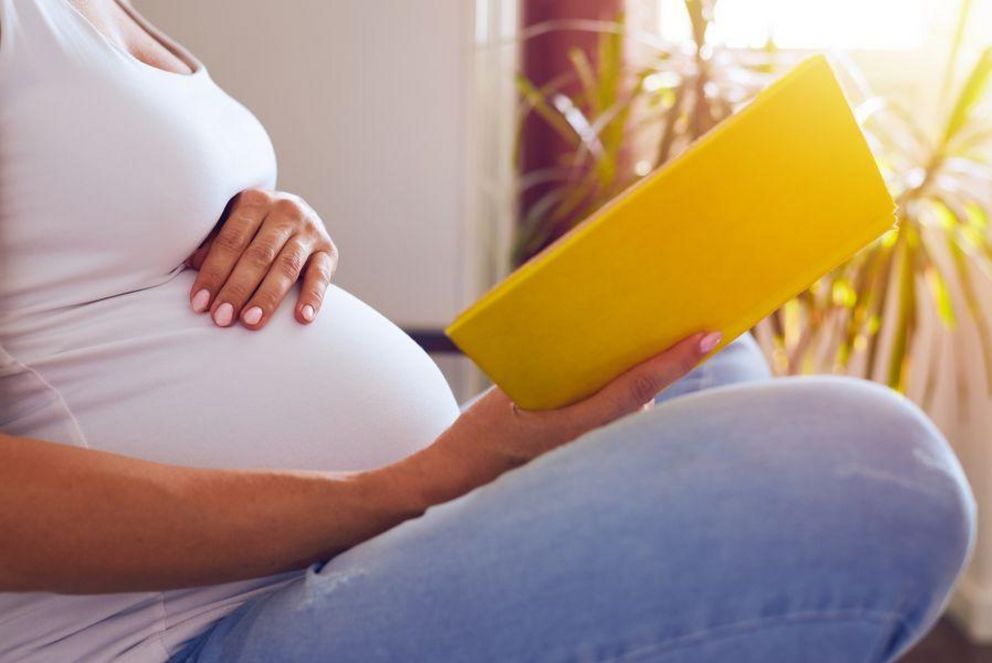 Pregnant woman with a book