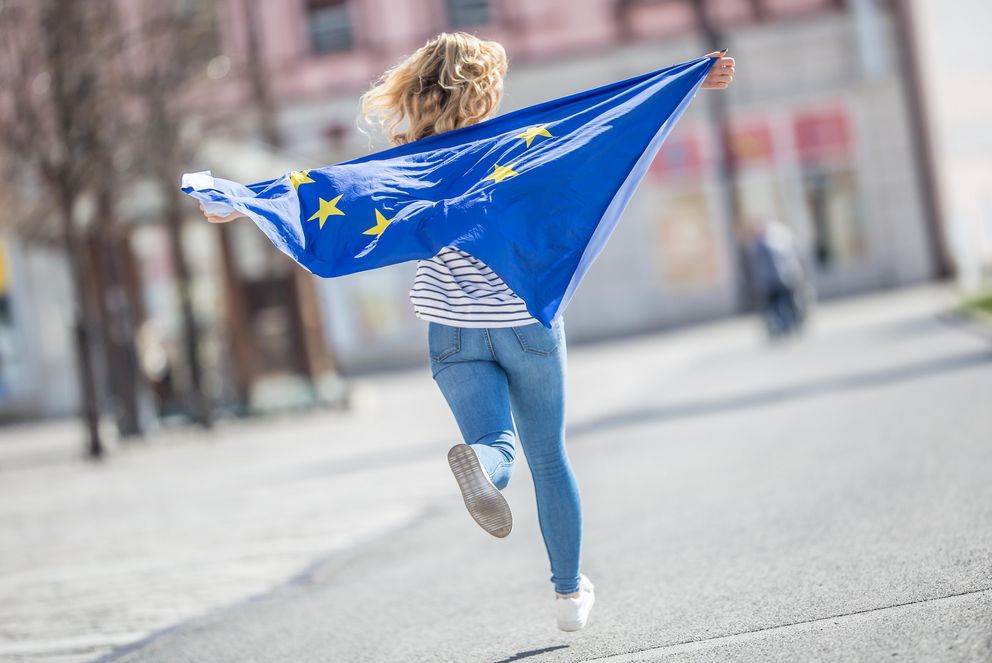 [Translate to Englisch:] Eine laufende Frau mit einer Europaflagge